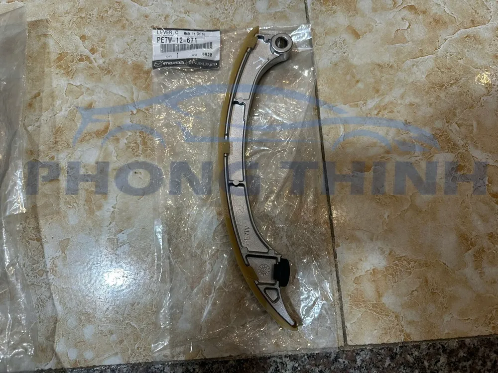 Tỳ xích cam cong Mazda 3, Mazda 6 & CX5 2.0 chính hãng - PE7W12671
